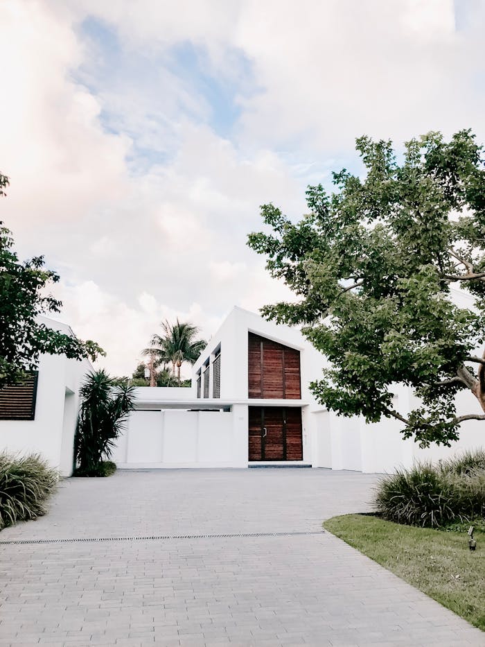 services-02 Contemporary minimalist home exterior with lush landscaping and open driveway.